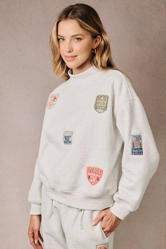Sunday Edition by LE LIS - HIGH NECK LONG SLEEVE "SKI PATCHES" SWEATSHIRT