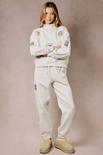 Sunday Edition by LE LIS - HIGH NECK LONG SLEEVE "SKI PATCHES" SWEATSHIRT